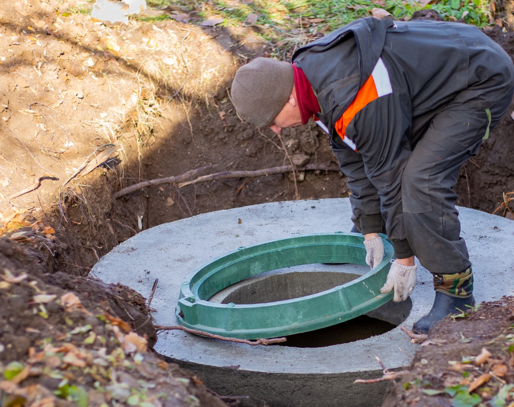 man working on a septic tank